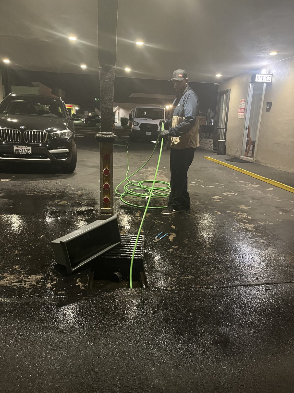 Lay It Rite Plumbing running a sewer camera inspection in an Orange County parking garage drain
